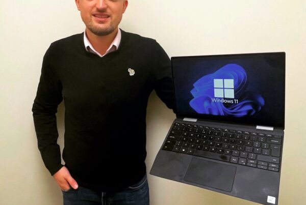 Oliver Alcock holds refurbished Dell Laptop