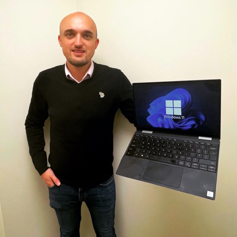 Oliver Alcock holds refurbished Dell Laptop